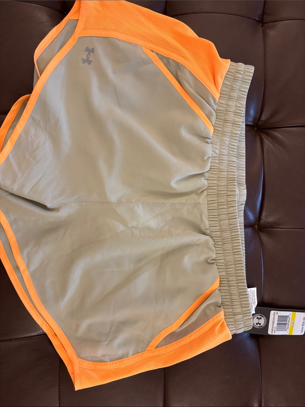 Under Armour light grey Athletic Shorts with Neon Orange Trim.